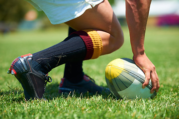 Image showing Hand, rugby and ball with a sports man playing a game on a grass field for competition or recreation. Fitness, training and health with a male athlete getting ready to play a match outdoor in summer