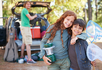 Image showing Happy siblings, portrait and hug for camping holiday, road trip or family vacation together in nature. Sister hugging brother with smile and lantern for camp adventure, travel or getaway in forest