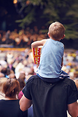 Image showing Back, festival and a boy sitting on dad shoulders outdoor at a music concert together for bonding or entertainment. Family, kids and crowd with a father carrying his child son outside at an event