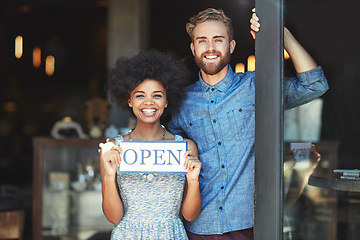 Image showing Coffee shop, open and couple portrait as small business owner or team in partnership with pride. Smile of a man and woman with signage, diversity and welcome sign as waiter and barista of restaurant