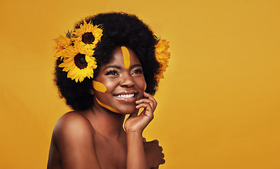 Image showing Sunflower, beauty and happy black woman in studio for makeup, wellness and treatment on yellow background. Flower, skincare and African female model smile, relax and pose with natural skin cosmetics