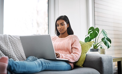 Image showing Relax, home and woman on a couch, laptop and typing with connection, search internet and online reading. Female person, pc and lady on a sofa, technology and chilling with a movie in the living room