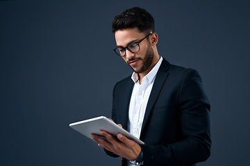 Image showing Technology, professional young businessman with tablet and in a studio background. Social networking or digital communication, isolated and male person with mobile device search on backdrop.