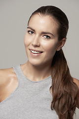 Image showing Happy woman, portrait and smile for fitness, exercise or cardio workout against a grey studio background. Face of fit, active and sweaty female person or model smiling in sportswear or exercising