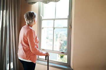 Image showing Senior woman, nursing home and window for thinking, vision or ideas with walking stick, disability or rehabilitation. Elderly lady, remember or looking ahead in retirement, house or memory in morning