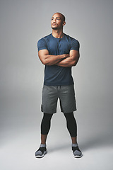 Image showing Arms crossed, fitness and man thinking isolated on studio background for healthy body and workout ideas. Confident, vision and strong athlete, bodybuilder or African person, exercise and sports power