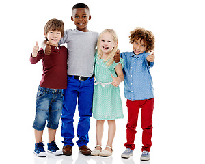 Image showing Kids, group and thumbs up for diversity in studio portrait with smile, hug or care by white background. Girl, boy or isolated friends for happiness, hand sign or solidarity for children with kindness