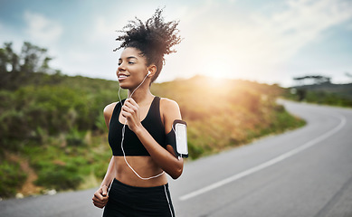 Image showing Fitness, sports and happy woman running in a road with music for health, workout or cardio routine. Smile, exercise and African female runner in nature with podcast for training, motivation or energy