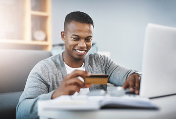 Image showing Home, ecommerce and man with a credit card, laptop or happiness for payment. Male person, customer in the living room or happy client with a pc, technology or smile for online shopping and sale