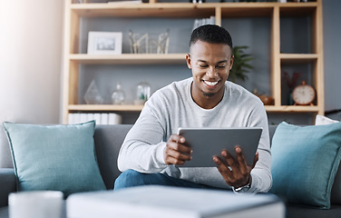 Image showing Smile, tablet and man on sofa on social media meme, email or streaming video on subscription service. Happiness, internet and networking, happy male surfing online and movie website on couch in home.