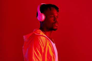 Image showing Headphones, fashion and black man profile with music and online song streaming. Internet radio, web audio and African male model with red background in a studio with gen z style and neon lighting