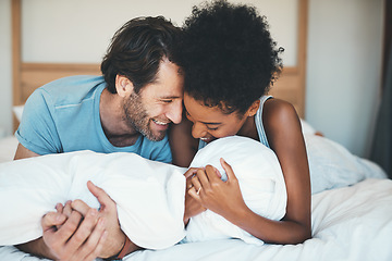 Image showing Happy interracial couple, bed and laughing in relax for intimate morning, bonding or relationship at home. Man and woman smiling with laugh in joyful happiness or relaxing weekend together in bedroom