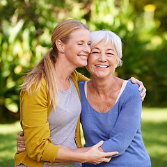 Image showing A mother with adult daughter hug outdoor, happiness and spending quality time in garden or park together. Family, happy women are caring in relationship with love, bonding and carefree in nature