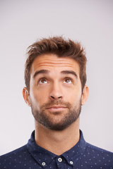 Image showing Thinking, looking up and man in studio with solution, ideas and relax with eyes and mockup. Isolated, gray background and male model face think and distracted with planning with decision alone