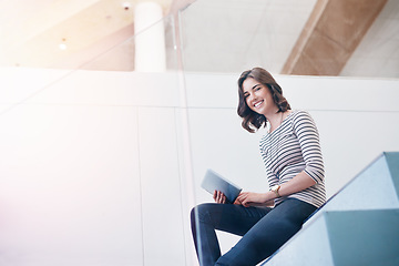 Image showing Tablet, portrait and businesswoman on the stairs in the office doing research for corporate project. Happy, smile and professional female employee working on company report with mobile in workplace.