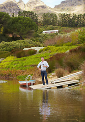 Image showing Portrait, river and a man drinking red wine on a pier outdoor in nature on his farm for agriculture. Water, drink and alcohol with a happy farmer enjoying a beverage while farming for sustainability