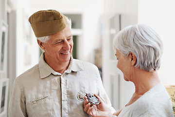 Image showing Military, medal and honor with a senior couple in their home, feeling nostalgic about army service. War hero, award or memory and a mature man soldier in a house with his wife, feeling patriotic