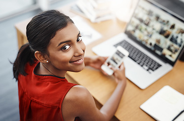 Image showing Laptop, phone and portrait of a business woman with website for media, research and creative work or blog. Happy Indian female entrepreneur at a desk with a smartphone and internet while typing