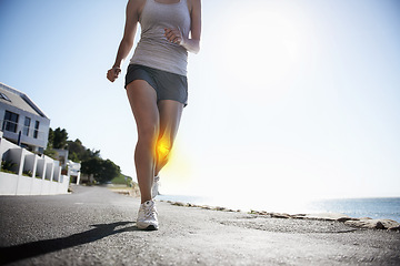 Image showing Woman, running and knee x ray for injury, workout or sport accident during exercise or run in the city. Female runner in body fitness with sore leg, ache or bone from exercising or training on road