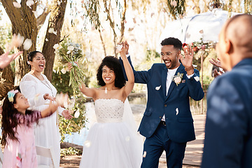 Image showing Wedding day, couple celebrate and confetti outdoor with happiness and hands up at marriage event. Celebration, happy people and African bride walking with flower bouquet at love commitment ceremony