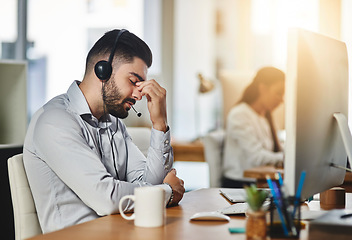 Image showing Headache, stress or tired man in call center with burnout, head pain or overworked in crm communication. Migraine, office or telemarketing sales agent frustrated with anxiety, fatigue or problems