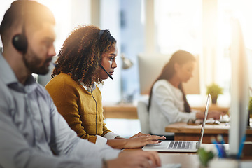 Image showing Communication, coworking or woman in call center consulting or typing on laptop at customer services. Virtual assistant, girl or female sales consultant in telemarketing or telecom company help desk