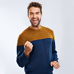 Image showing Portrait, cheering and man excited, celebration and winning with guy isolated against a studio background. Face, male and happy person with fist, winner and excitement with happiness and victory