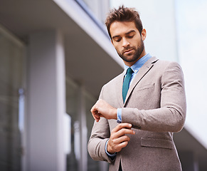 Image showing Person, professional and businessman in formal or smart suit and in city background. Travel worker or corporate employee, entrepreneur and male fashion model fixing long sleeve outdoors downtown