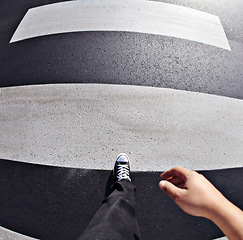 Image showing Pov, shoes and man in a road at a pedestrian crossing for weekend, travel and fun in a city. Above, feet and walking male outdoors for fun, walk and commute or solo travelling in town in the morning