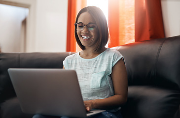 Image showing Home, smile and woman with a laptop, couch and typing with connection, network and online reading. Female person, freelancer and entrepreneur with pc, technology and lady search internet and website