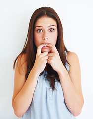 Image showing Portrait, nervous and biting nails with a woman in studio isolated on a white background for psychology. Stress, anxiety and mental health with a scared young female person looking terrified in fear