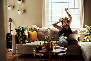 Image showing Music, headphones and woman on sofa and laptop dancing, happy energy and mental health in boho apartment. Young person listening to audio technology, electronics and computer in living room or home