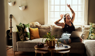 Image showing Woman, dancing and headphones on couch and laptop, happy energy or mental health with music at home. Young gen z person on sofa singing, dance and listening to audio tech on computer in living room