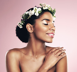 Image showing Happy woman, crown of flowers and makeup in studio, pink background and natural skincare aesthetic. African face, female model and floral headband for beauty, sustainable cosmetics and spring fashion