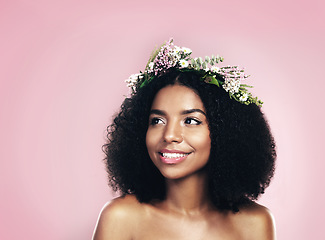 Image showing Woman, thinking and flower crown for beauty in studio, pink background and mockup of natural hair or skincare. Face, happy african model and daydream with floral wreath for sustainable cosmetic ideas