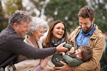 Image showing Happy family, child and people playing with kid in a park on outdoor vacation, holiday and excited together. Grandparents, happiness and parents play with kid as love, care and bonding in nature