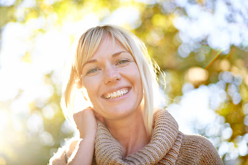 Image showing Women, face and smile portrait outdoor in nature with trees, happiness and lens flare in spring. Female model person happy about travel, adventure and holiday in countryside or park for peace