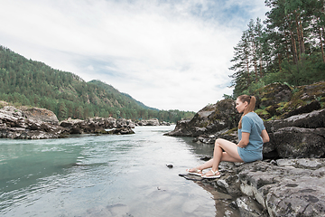 Image showing Woman resting at river