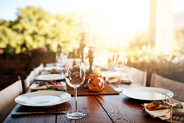 Image showing Thanksgiving, dinner table and decoration for a party, banquet or celebration in the backyard. Plate, wine glass and decor with a rustic elegant dining set, cutlery and tableware outside feast.