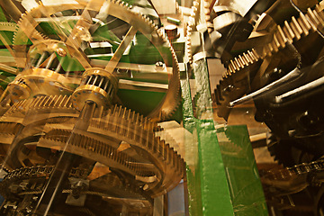 Image showing Clock, gears and machine wheel interior with brass mechanics and engine. Gear cog, wheels and golden time mechanism with machinery and cogs for speed, transport and mechanical work of vehicle