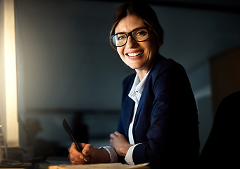 Image showing Portrait, businesswoman and writing at night or glasses or smile and pc in formal office. Corporate, dark and female worker or professional or manager in the evening and company or emails on computer