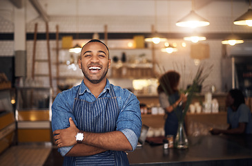 Image showing Coffee shop, waiter and portrait of black man laugh in restaurant for cafe service, working and crossed arms. Small business owner, bistro startup and happy male barista in cafeteria ready to serve