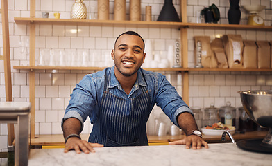 Image showing Coffee shop, happy and portrait of black man in restaurant for service, working and welcome in cafe. Small business owner, barista startup and male waiter smile in cafeteria ready to serve by counter
