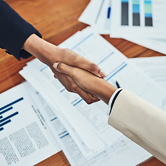 Image showing Business people, handshake and partnership in meeting above for b2b, deal or document agreement at the office. Top view of employees shaking hands for planning, strategy or teamwork at the workplace