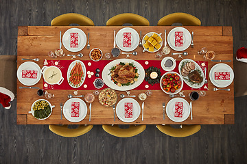 Image showing Dinner, table and Christmas lunch with food at an event from top view or above of a home dining room for celebration. Chicken, party and holiday or vacation vegetables and meat for fine dining