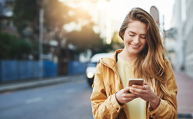 Image showing Woman, smile at smartphone with communication while in city, chat on social media and connectivity outdoor. Happy young person and student in urban street, text contact with mobile app and technology