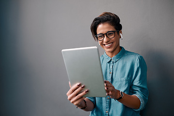 Image showing Tablet, music and happy woman or student isolated on gray background for university e learning, online streaming and video. Young person on digital technology, listening to audio and electronics app