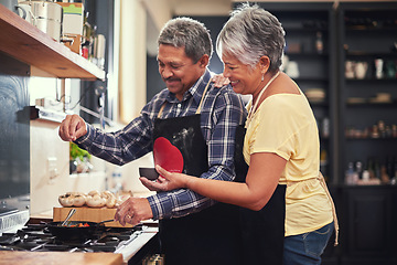 Image showing Food, happy senior couple cooking in kitchen and at their home. Collaboration or teamwork of partners, family or marriage and smiling people baking or preparing a meal together in their house