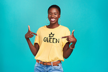 Image showing Queen, print and tshirt on a black woman for equality and human rights isolated in a blue background studio. Fashion, fearless and African gen z or female person happy with quotes in her clothes