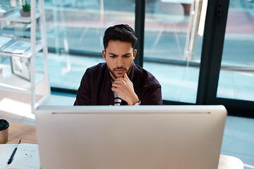 Image showing Serious, computer and a business man thinking while working at a desk and online for research. Male entrepreneur person confused while reading email or data analytics with internet connection